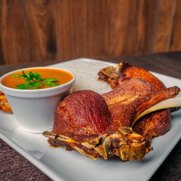 El Cerro's Latin-American dish with crispy fried pork chops, white rice, and a side of soup.